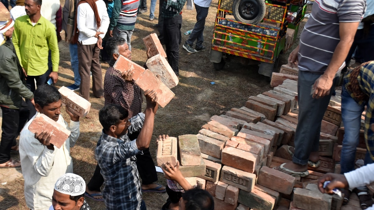 People carry bricks in view of former TMC MLA Humayun Kabir's plan to lay the foundation stone for a mosque, modelled on Ayodhyas Babri Masjid, at Rejinagar in West Bengals Murshidabad district