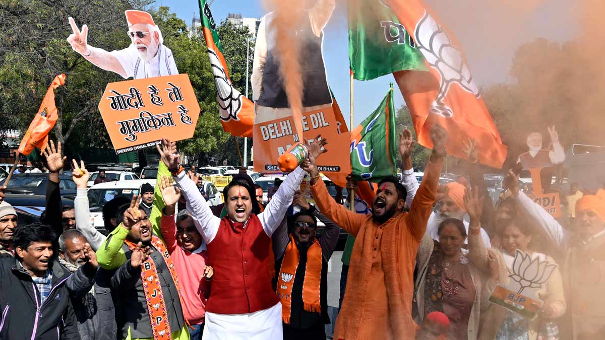 BJP supporters celebrate the party's decisive lead in the Delhi Assembly polls as counting of votes is underway, outside the Delhi BJP state office in New Delhi | Josekutty Panackal 