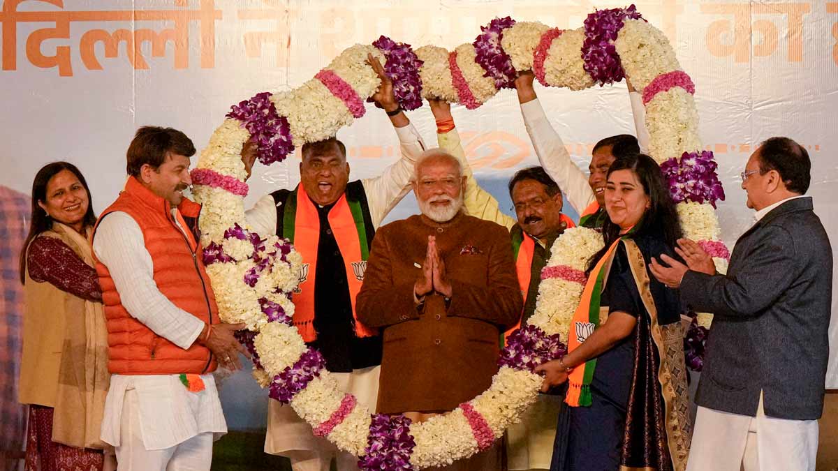 Prime Minister Narendra Modi being garlanded by BJP MPs Manoj Tiwari, Ramvir Singh Bidhuri and Bansuri Swaraj during celebrations at the BJP HQ after the party won the Delhi Assembly election, in New Delhi | PTI