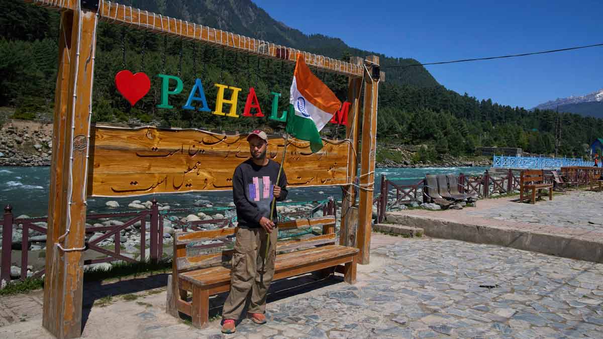 Arif Lone, an all-terrain vehicle owner, poses for a photograph with the Indian national flag at a deserted selfie point before participating in a Tiranga Yatra or tricolor march to highlight the success of Operation Sindoor, in Pahalgam | AP