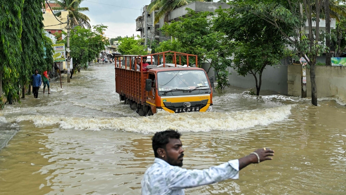 A truck makes way through a flooded street following heavy rainfall in Bengaluru on May 19 | AFP 