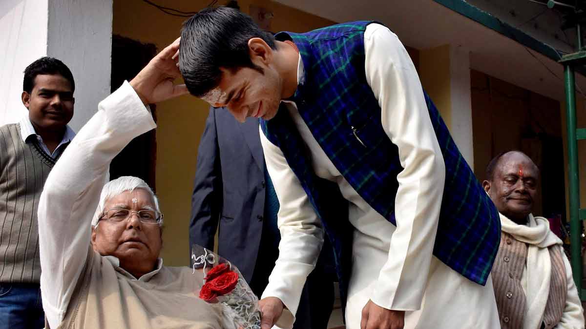 [File] RJD leader Tej Pratap Yadav takes blessings of his father and party chief Lalu Prasad | PTI