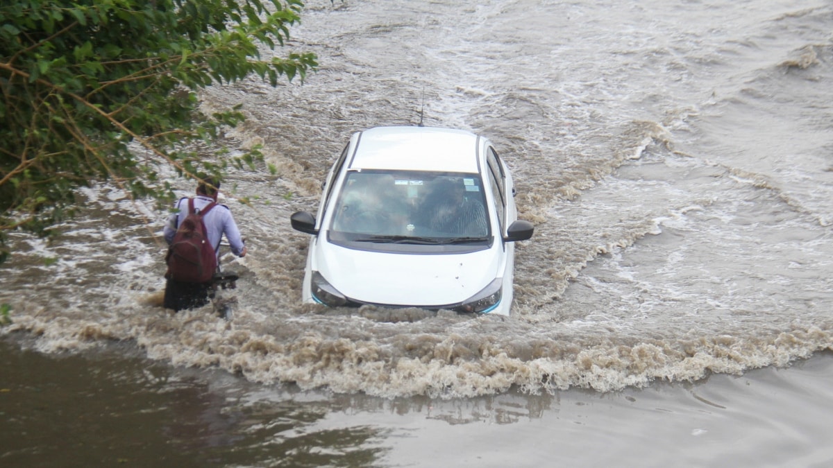 A car moves on the waterlogged service road along the Delhi-Gurugram Expressway after heavy rainfall | PTI