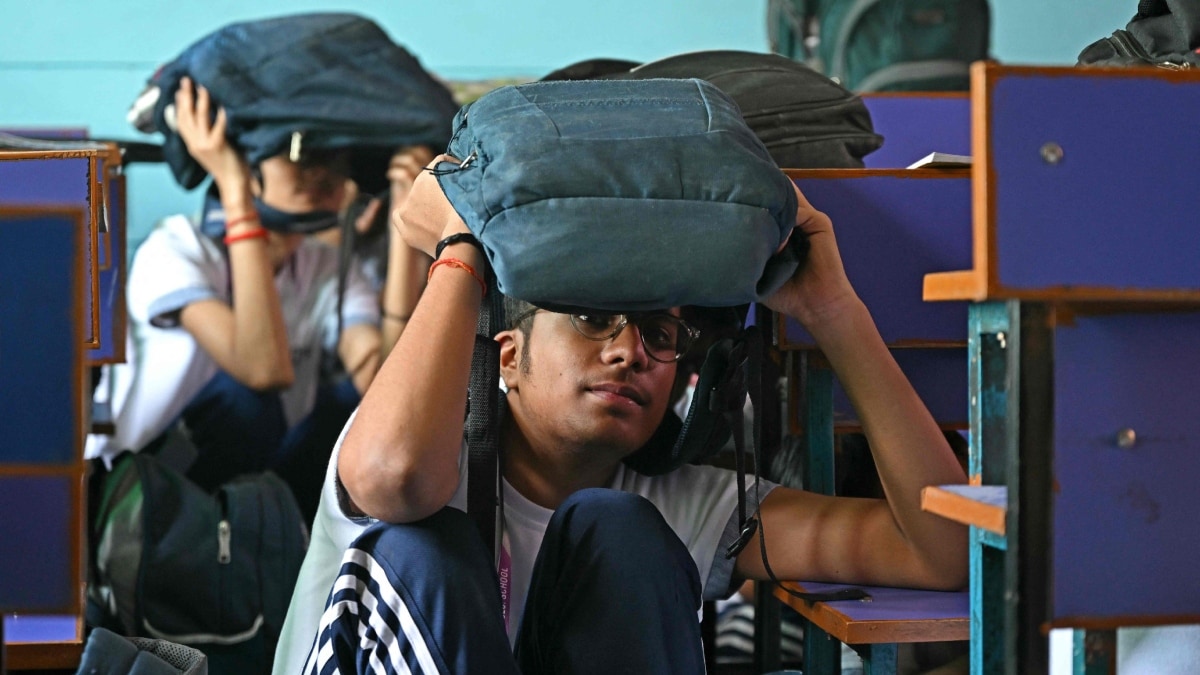 Students take part in an emergency mock drill as part of the nationwide civil defence mock drill at a school in New Delhi | AFP