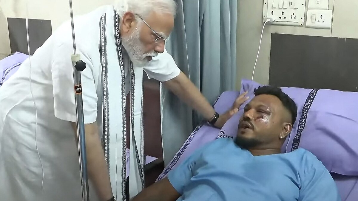 TOPSHOT - This screengrab of video footage taken and released by the Narendra Modi Youtube Channel on June 13, 2025 shows India's Prime Minister Narendra Modi (L) meeting with Vishwash Kumar Ramesh, sole survivor of the Air India flight 171 crash, at a hospital in Ahmedabad. Rescue teams with sniffer dogs combed the crash site on June 13 of the London-bound passenger jet which ploughed into a residential area of India's Ahmedabad city, killing at least 265 people on board and on the ground. (Photo by NARENDRA MODI YOUTUBE CHANNEL / AFP) / -----EDITORS NOTE --- RESTRICTED TO EDITORIAL USE - MANDATORY CREDIT "AFP PHOTO / Narendra Modi Youtube Channel " - NO MARKETING - NO ADVERTISING CAMPAIGNS - DISTRIBUTED AS A SERVICE TO CLIENTS