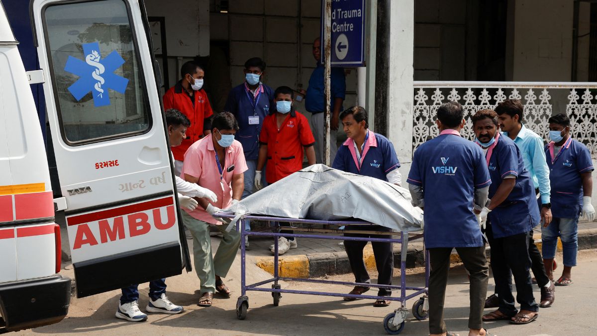 Health workers shift the body of a victim, who died in the plane crash, to a cold storage at a hospital, in the aftermath of an Air India Boeing 787-8 Dreamliner crash | Reuters