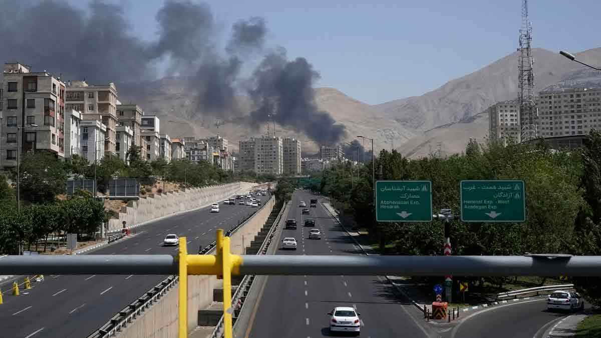 Smoke rises from an oil storage facility after it appeared to have been struck by an Israeli strike, in Tehran | AP