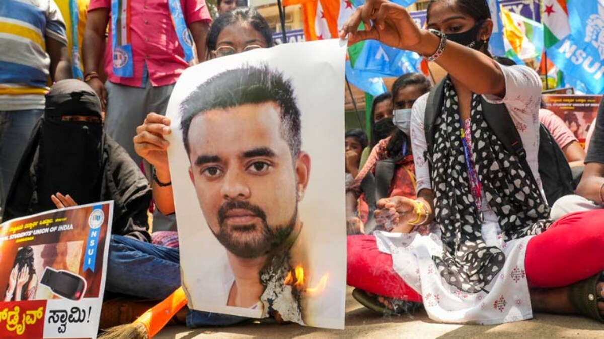 [FILE] NSUI members burn a poster of JD(S) MP Prajwal Revanna during a protest against his involvement in the alleged sexual abuse case, in Bengaluru.