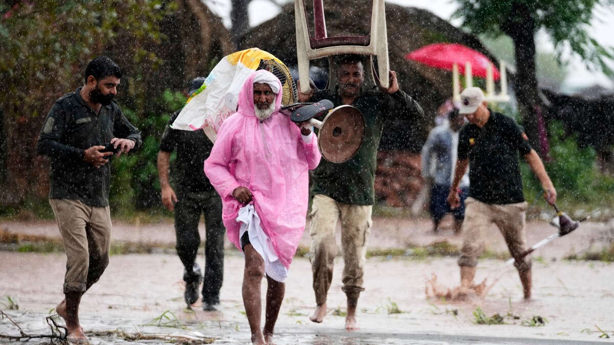 Jammu and Kashmir Police assist in rescuing residents as they evacuate their homes and move to safer areas after the River Chenab overflowed following heavy rainfall | AP