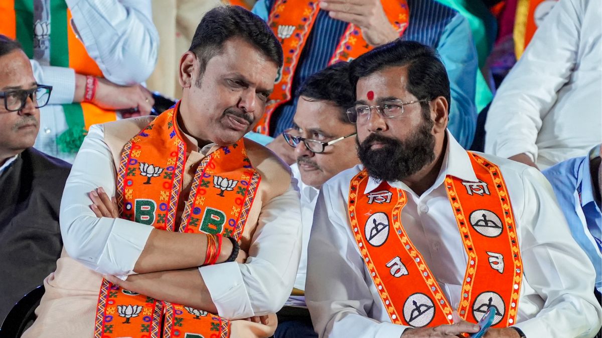 Maharashtra Chief Minister Devendra Fadnavis, left, in a conversation with state Deputy Chief Minister Ekanth Shinde during a rally for the BMC elections, in Mumbai | PTI