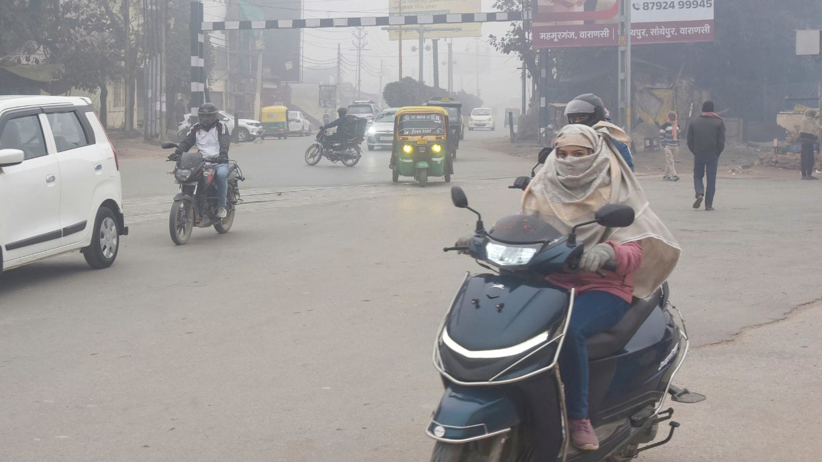 Commuters make their way amid fog and low visibility on a cold winter morning in Varanasi | PTI