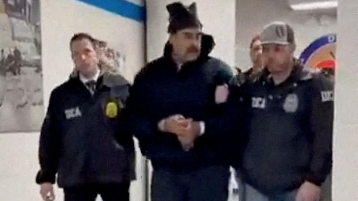 A still image from video posted by the White House's Rapid Response 47 account on X.com shows Venezuela's President Nicolas Maduro being walked in custody down a hallway at the offices of the U.S. Drug Enforcement Administration (DEA) in New York City | Reuters 