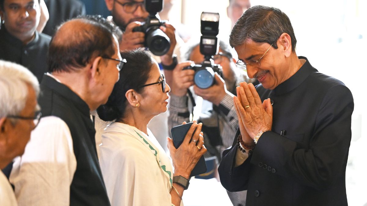 West Bengal Chief Minister Mamata Banerjee, centre, greets newly appointed Governor R.N. Ravi, right, during his swearing-in ceremony, at Lok Bhavan in Kolkata | Salil Bera