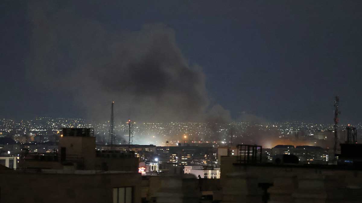 A plume of smoke rises from the site of a strike in Tehran on March 28 | AFP
