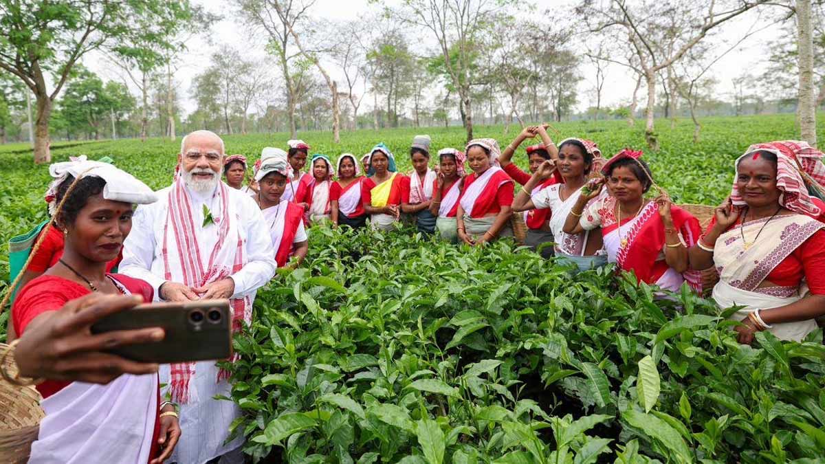 Prime Minister Narendra Modi with tea garden workers at the Manohari Tea Estate in Dibrugarh | X