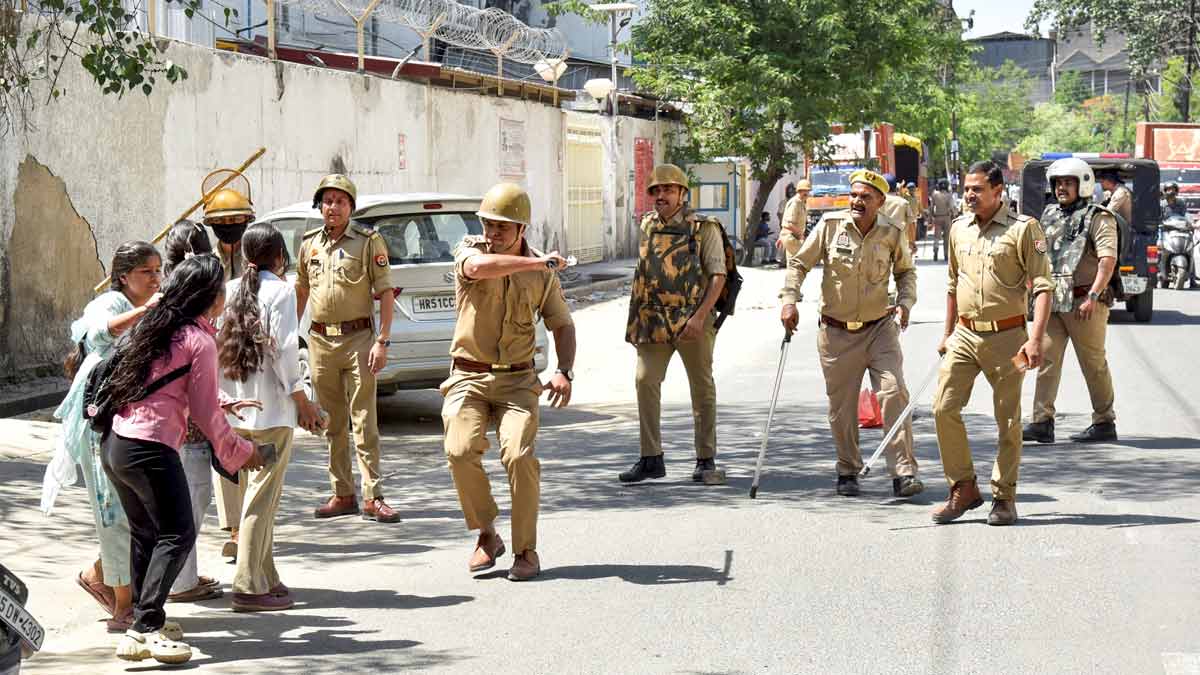 Police personnel resort to a lathi charge on protesters demanding a salary hike, in Noida | PTI