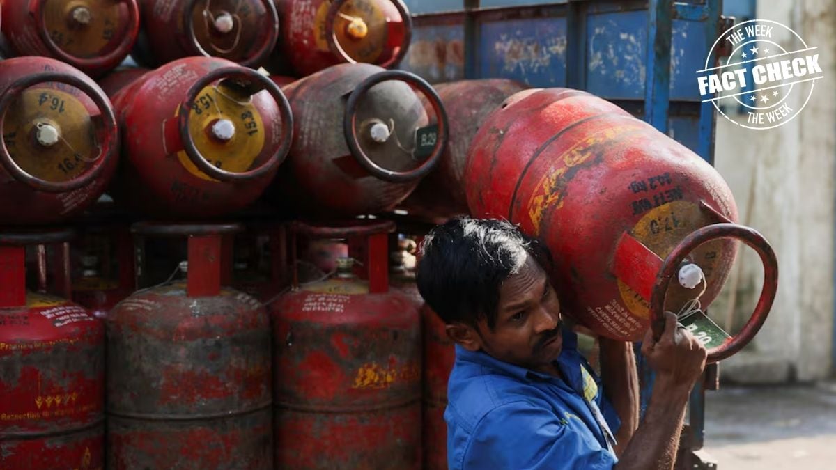 A man unloads an empty LPG cylinder at a warehouse | Reuters