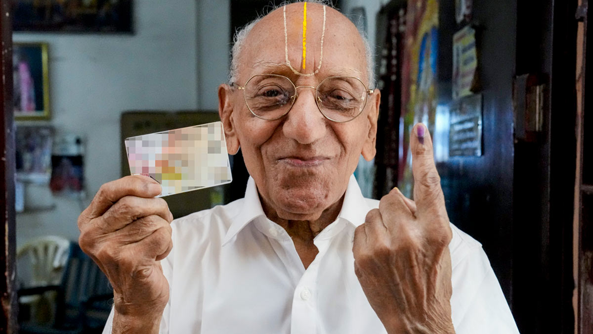 A 103 year old voter, Rajagopal, shows his identity card and his ink-marked finger after casting his vote for the Tamil Nadu Assembly elections | PTI