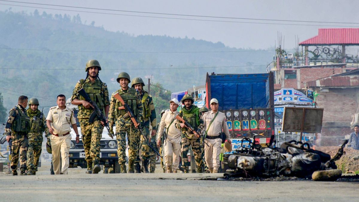 [File] Security personnel patrol near a burnt motorcycle following tensions in the Kanglatongbi area of Imphal West district of Manipur on April 23 | PTI