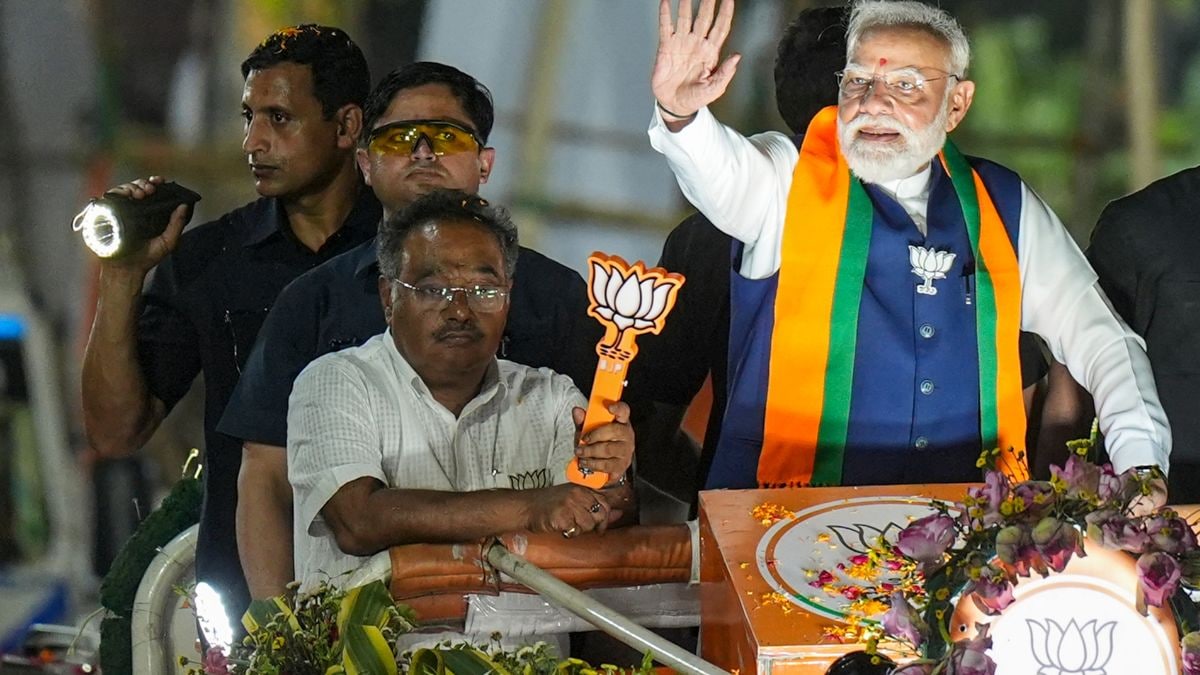 Prime Minister Narendra Modi with West Bengal BJP president Samik Bhattacharya during a roadshow amid the ongoing state Assembly elections, in Kolkata, West Bengal | PTI