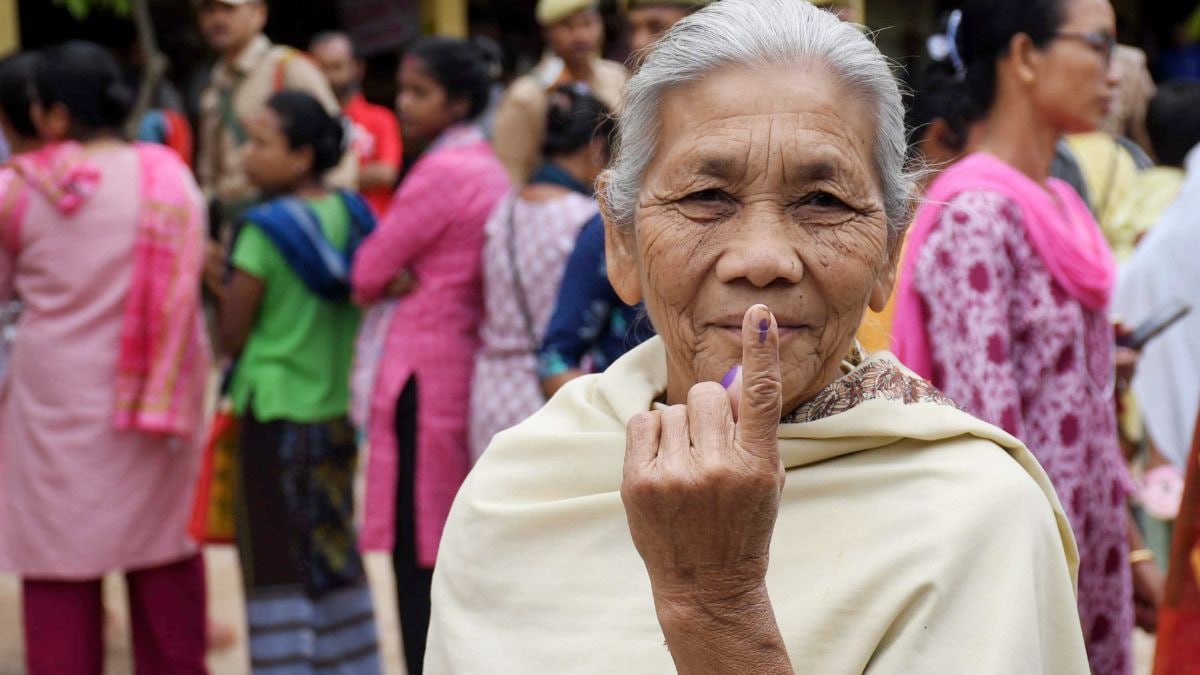 An elderly woman shows her ink-marked finger after casting vote during the Assam Assembly elections, at a polling station, in Guwahati | PTI