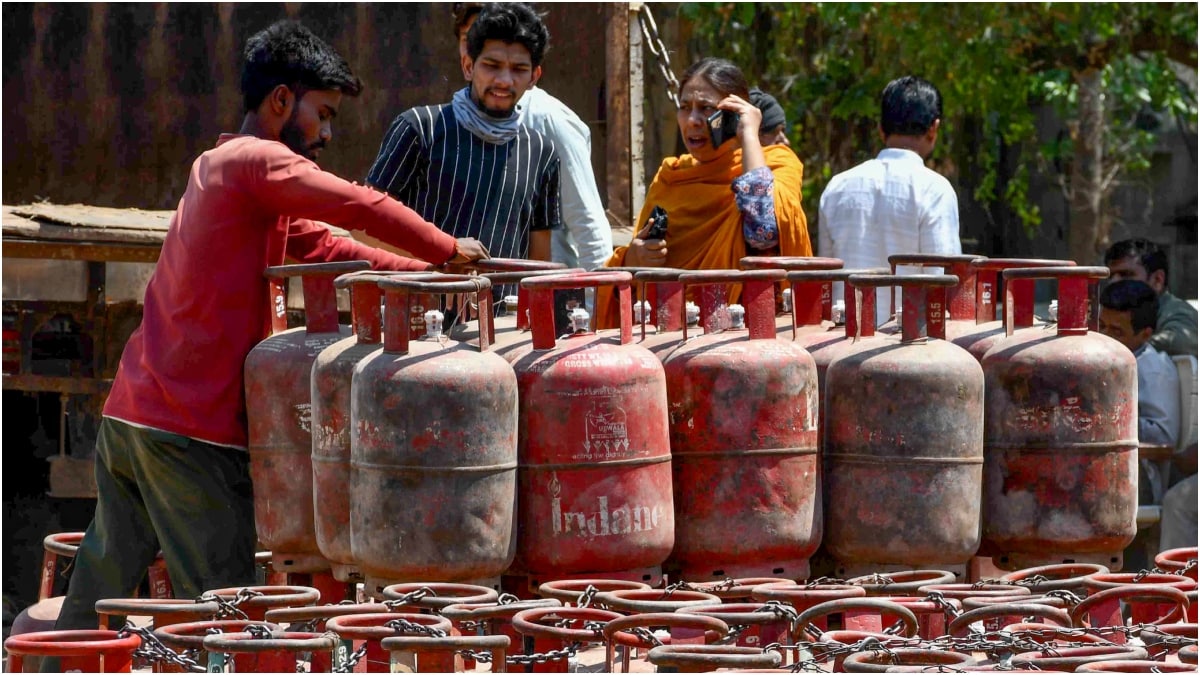  A man arranges LPG cylinders at a depot in Uttar Pradesh | PTI
