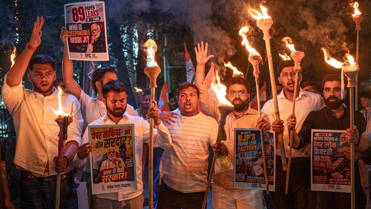 Youth Congress members take out a torchlight procession protesting against the alleged NEET-UG 2026 paper leak issue, in Haldwani | PTI