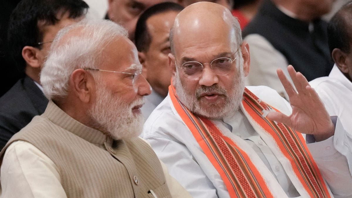 Prime Minister Narendra Modi in a conversation with Union Home Minister Amit Shah during a Civil Investiture Ceremony at Rashtrapati Bhavan | PTI