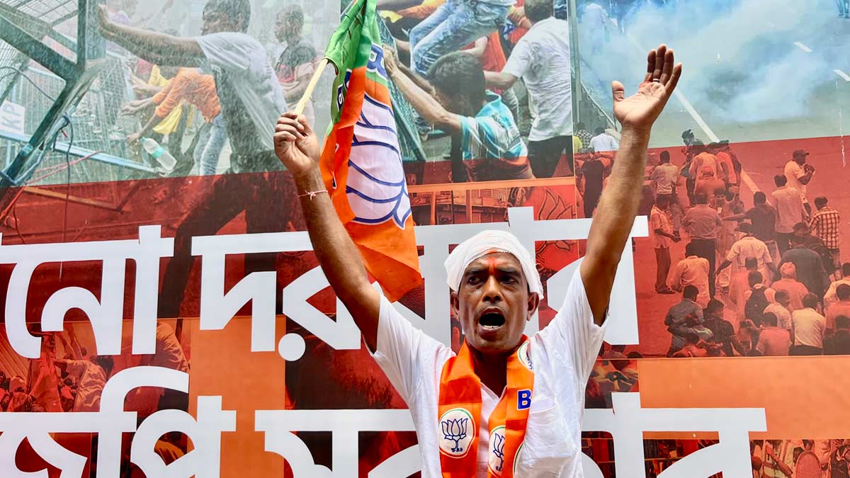A BJP worker celebrates in Kolkata as the pary is leading in majority of seats in West Bengal | Salil Bera