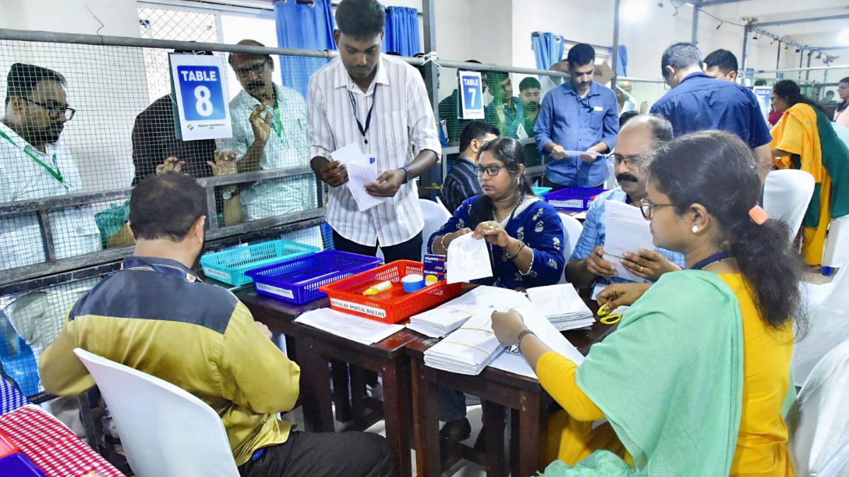 Election officials count postal ballots during the first round of vote counting for the Assembly elections at a counting centre, in Kozhikode, Kerala | PTI