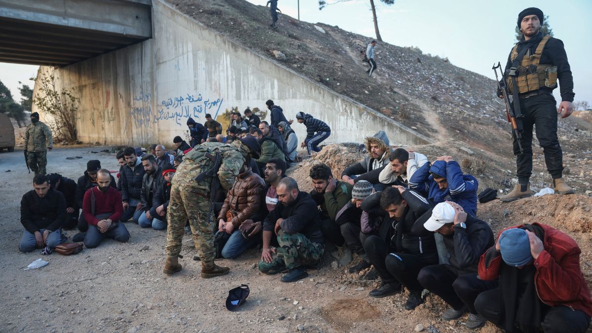 Government soldiers and allies sit on the floor as they are taken into custody by opposition fighters on the road between Homs and Damascus, near Homs, Syria, on Sunday, Dec. 8, 2024 | AP