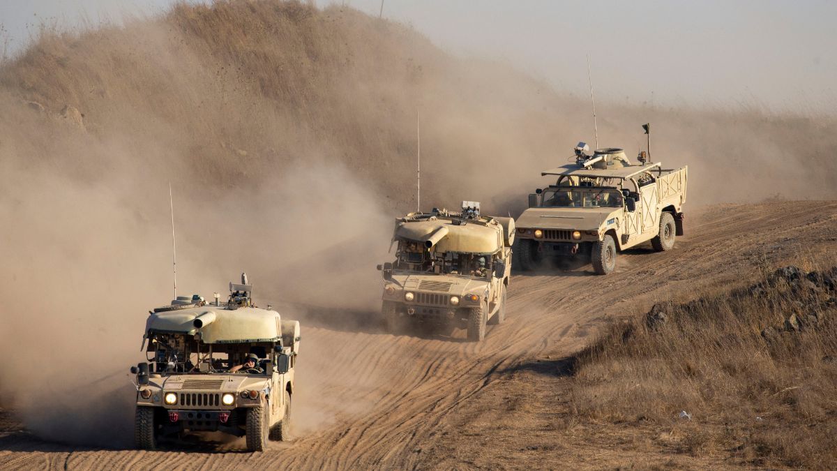 Israeli soldiers drive military vehicles during an exercise