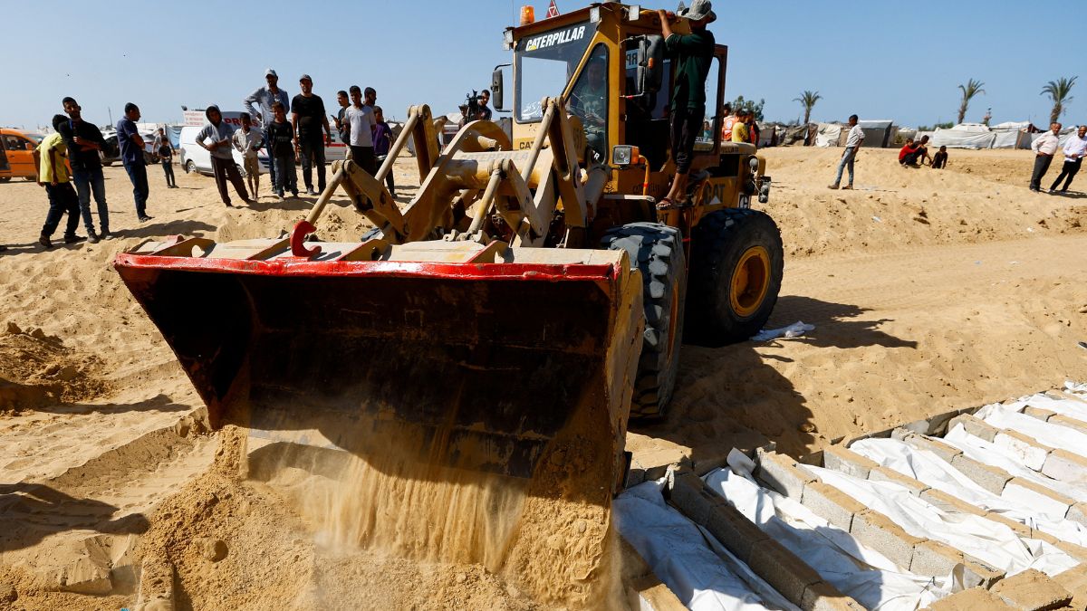 Heavy machinery assists with the burial of unidentified bodies of Palestinians who had been held in Israel during the war, after they were handed over by Israel, amid a ceasefire between Israel and Hamas in Gaza | Reuters 