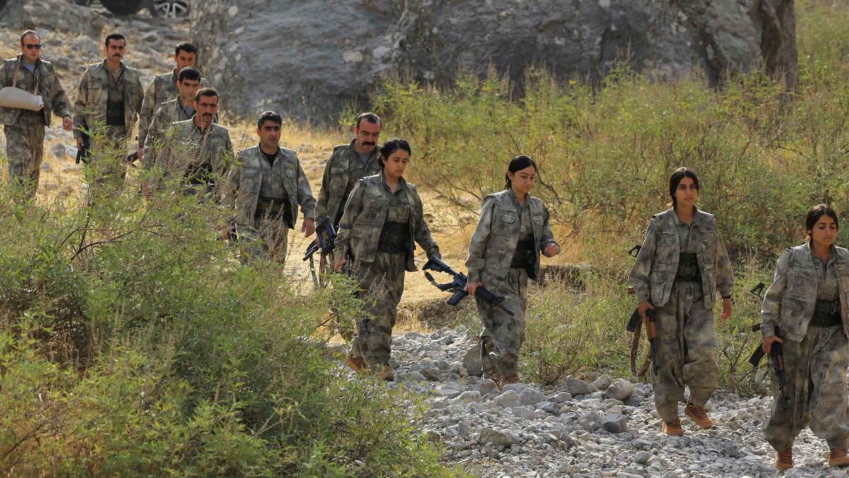 Fighters with the Kurdistan Workers' Party (PKK) walk for a disarmament ceremony marking a significant step toward ending the decades-long conflict between Turkey and the outlawed group | Reuters