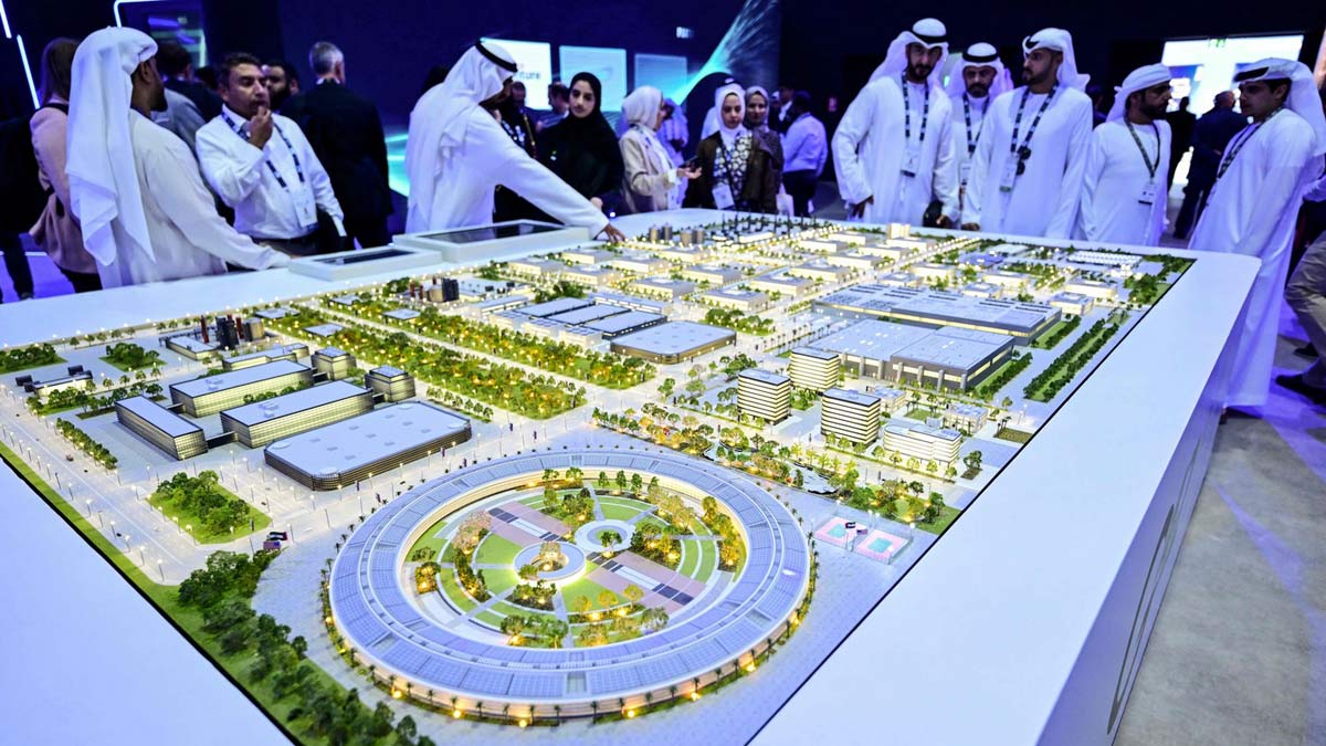 Guests look at a model of the largest data center in the UAE under construction in Abu Dhabi as the Stargate initiative, a joint venture between G42, Microsoft, and OpenAI, during the Abu Dhabi International Petroleum Exhibition & Conference