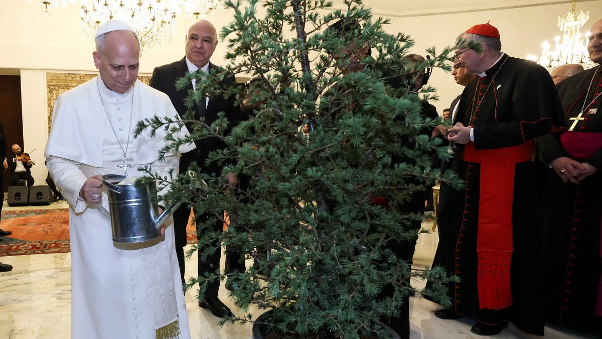 A handout photograph released by the Lebanese Presidency's press office shows Pope Leo XIV (L) watering a tree next to Lebanon's President Joseph Aoun (C) during a meeting at the presidential palace in Baabda, east of the capital Beirut | AFP 