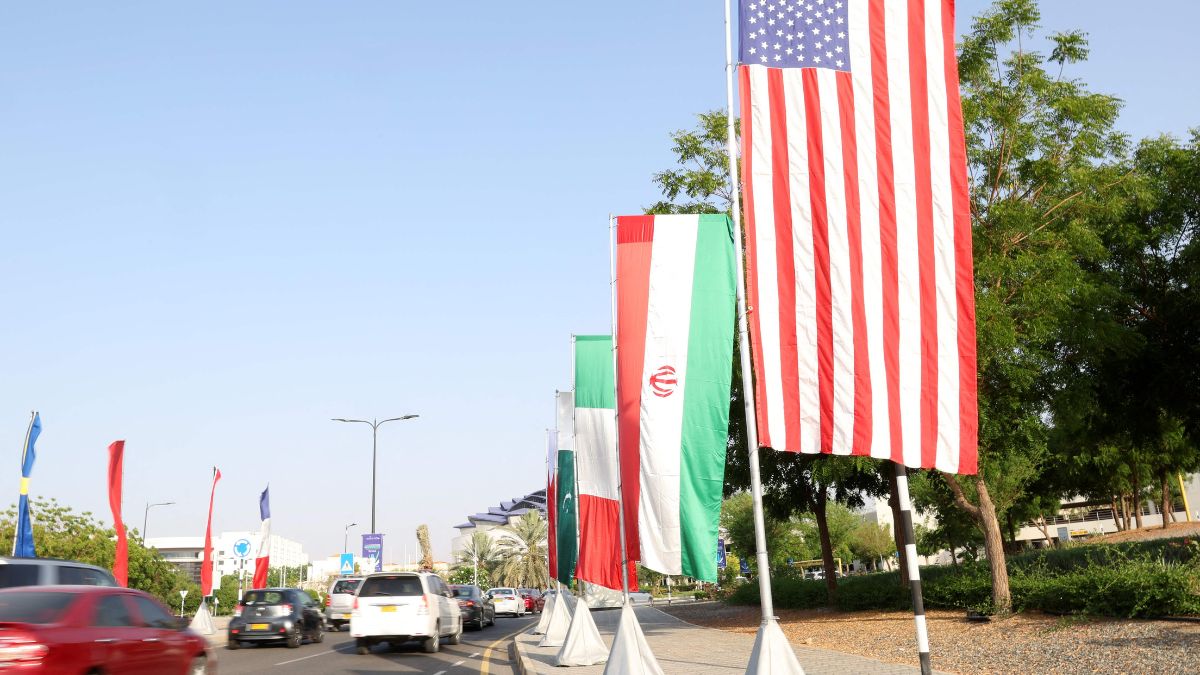 The flags of the US and Iran hang on the road leading to the Muscat International Book fair on April 25, 2025 | AFP