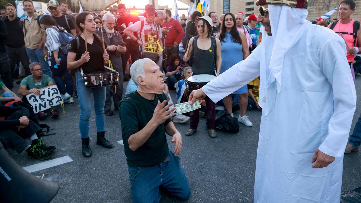 Israeli anti-government demonstrators take part in a protest calling for an end to the war in Gaza and the return of all the hostages held by Hamas, and against what has been dubbed locally as the "Qatargate Affair", outside the Israeli parliament in Jerusalem | AFP 