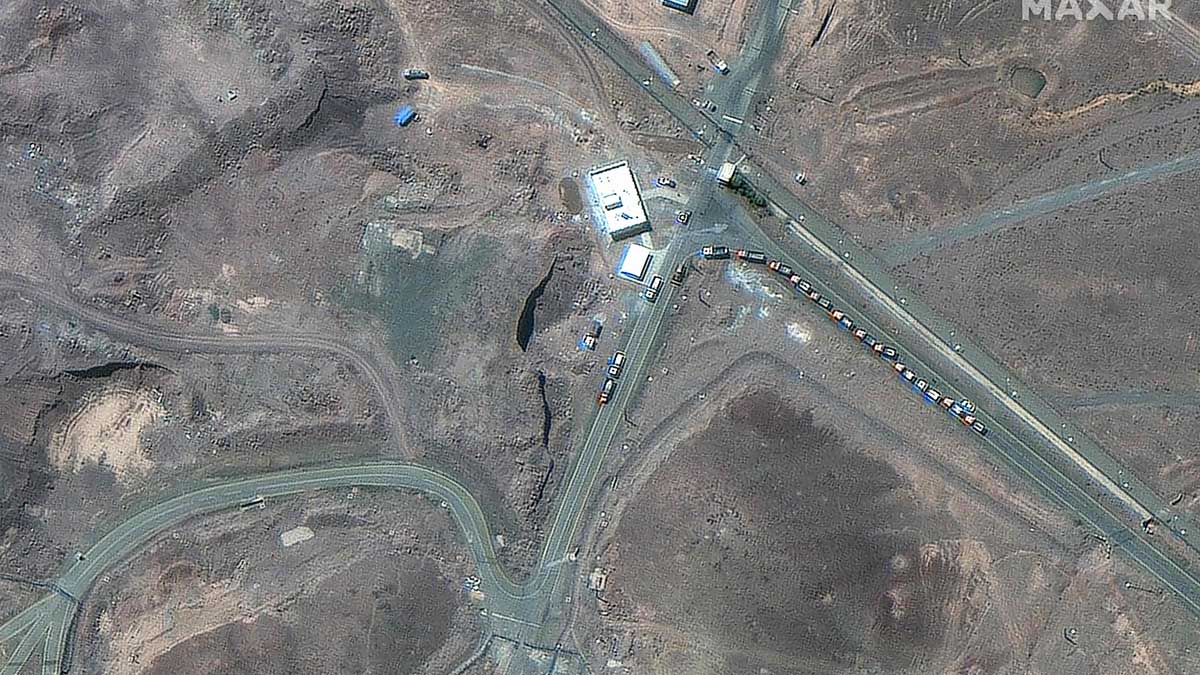 Cargo trucks postioned near an underground entrance to Iran's Fordow Fuel Enrichment Plant (FFEP), in Fordo | AFP
