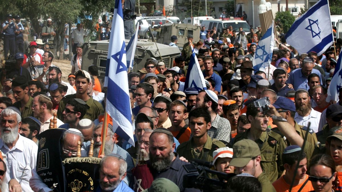  Israeli Jewish settlers march holding flags and two of them carrying Torah scrolls as they leave for the last time the Jewish settlement of Netzarim in the Gaza Strip, the last Gaza settlement to be evacuated | AP