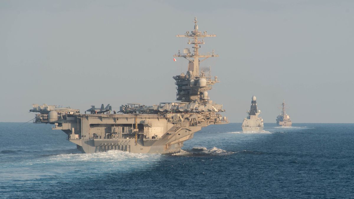 (File) The USS Abraham Lincoln aircraft carrier (L) transits the Strait of Hormuz | AFP 