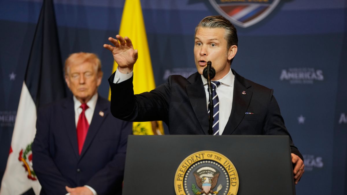 War Secretary Pete Hegseth speaks as President Donald Trump listens | AP