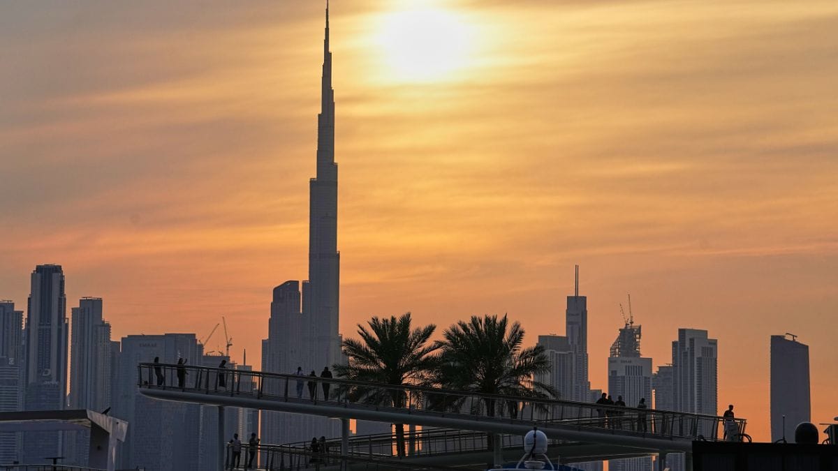 People enjoy the sunset with the view of the city skyline and Burj Khalifa, at Dubai Creek Harbour in Dubai, United Arab Emirates | AP
