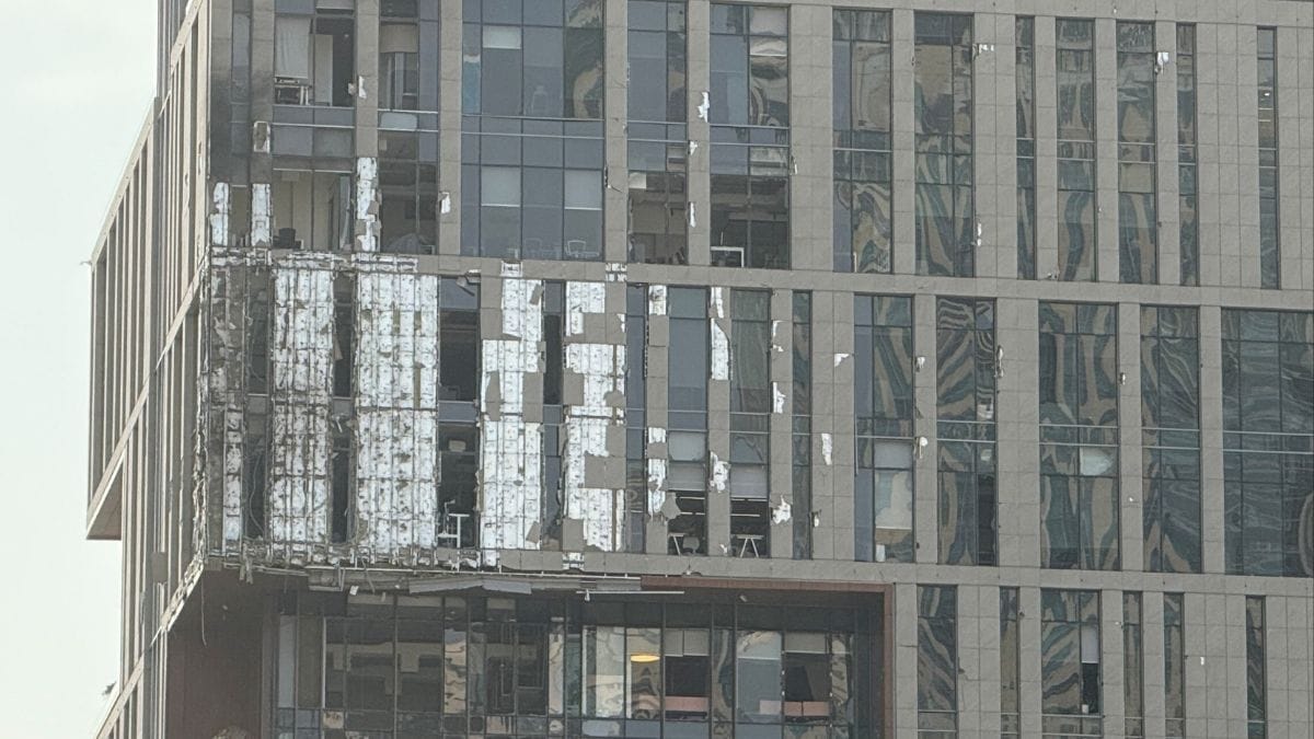 The damaged building in DIFC Dubai, after debris from a successful interception caused minor damage to the facade, amid the US–Israeli war with Iran, in Dubai, United Arab Emirates, on March 13, 2026 | REUTERS