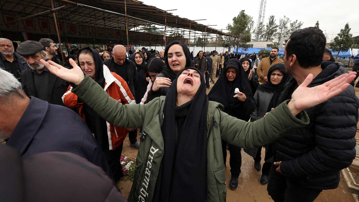 Relatives of Abdullah Pour Hossein, react during his funeral at Behesht-e Zahra cemetery, amid the U.S.-Israeli conflict with Iran, in Tehran | Reuters