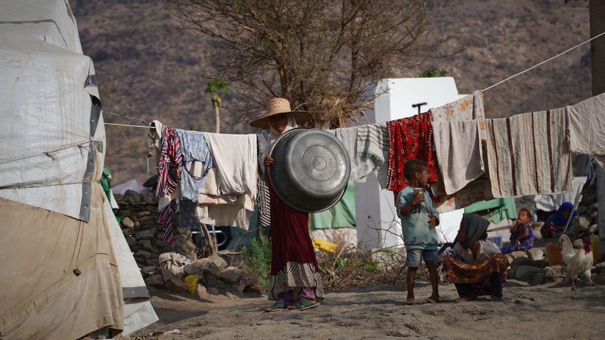 A displaced woman stands with her children in front of their tent at a makeshift camp in the al-Barakani area of rural Taiz, Yemen | AP