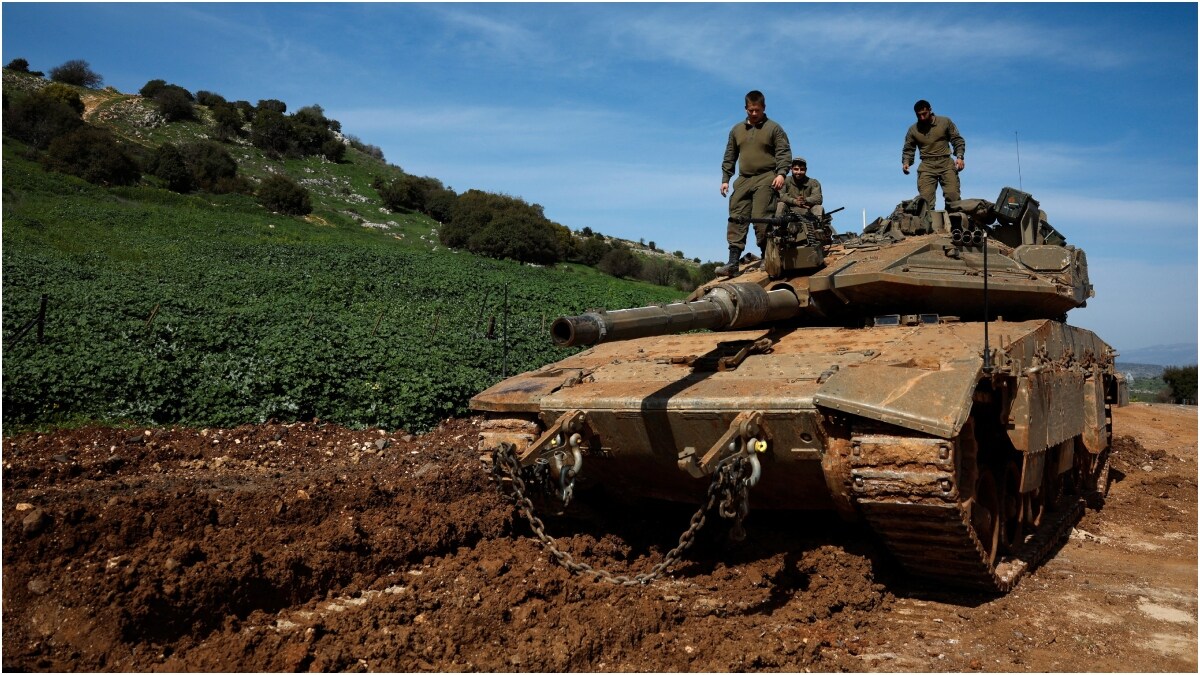 Israeli soldiers on a tank on the Israeli side of the border with Lebanon | Reuters