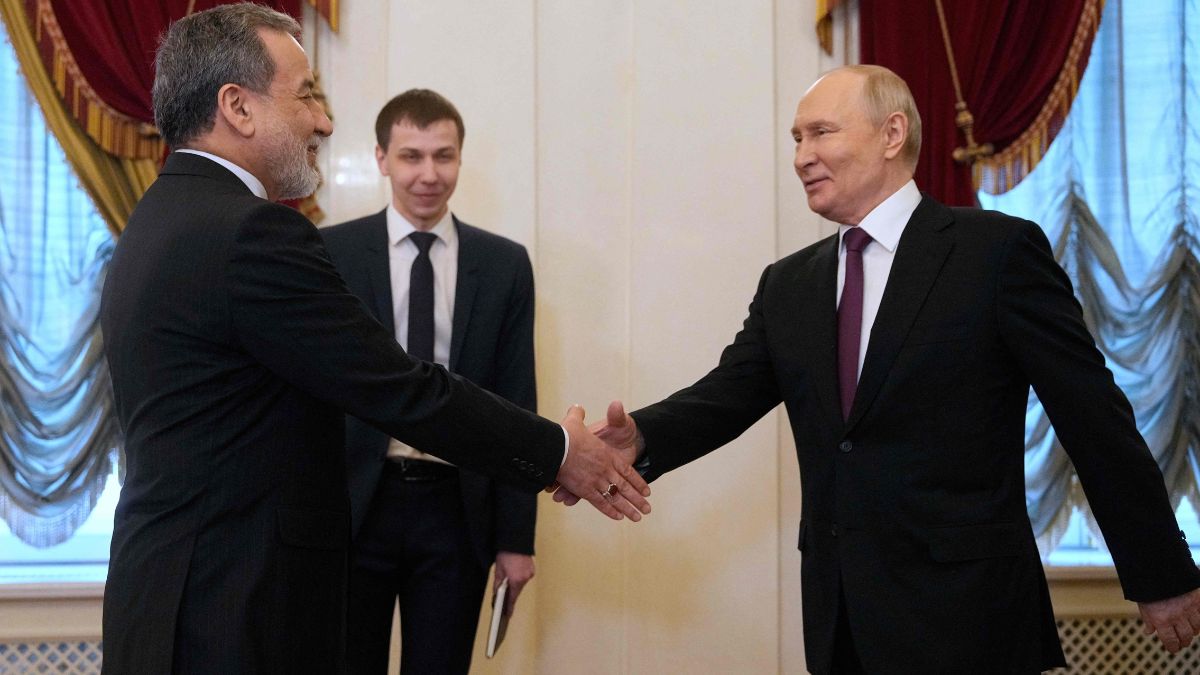 Russian President Vladimir Putin shakes hands with Iranian Foreign Minister Abbas Araghchi during their meeting at the Boris Yeltsin Presidential Library in Saint Petersburg | AFP