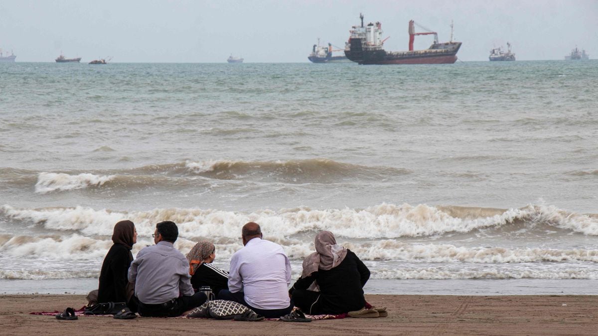 In this picture obtained from Iran's ISNA news agency on April 24, 2026, Iranians are seen at Suru Beach in Bandar Abbas along the Strait of Hormuz | AFP