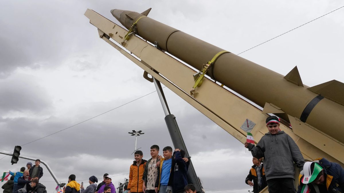 [File] People standing in front of an Iranian missile launcher during a February rally marking the 1979 Islamic Revolution | AP
